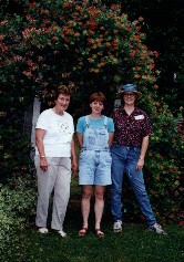 Kay and her 'volunteers'...Margie and Mary in front of the arbor with honeysuckle